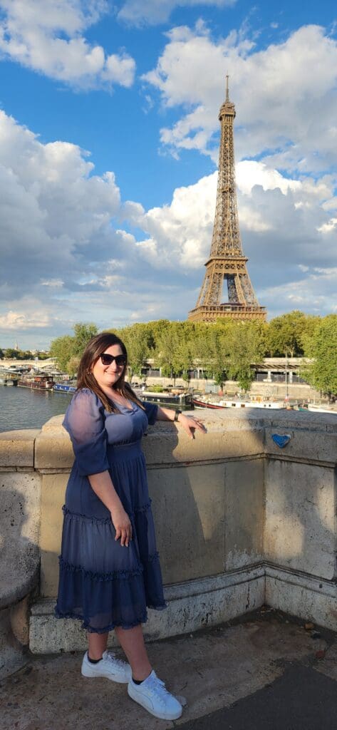 Mary, founder of Maryuterie, standing with the Eiffel Tower in the background in Paris, France