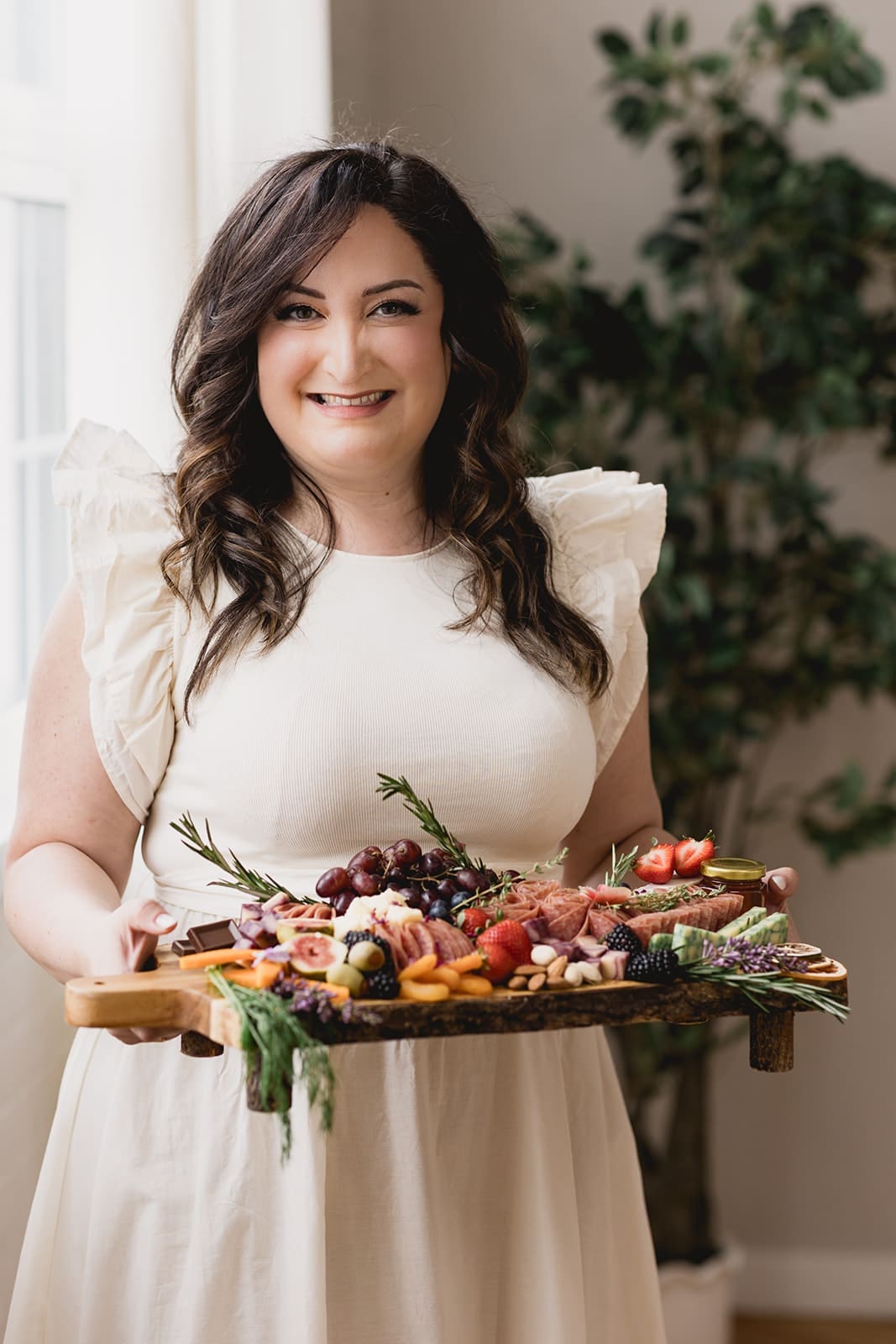 Mary, founder of Marycuterie holding charcuterie board