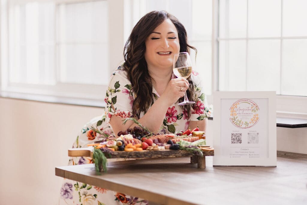 Photo of Mary, founder of Marycuterie, holding a glass of wine during a branding photoshoot with Portraits by Kendra in Kitchener-Waterloo