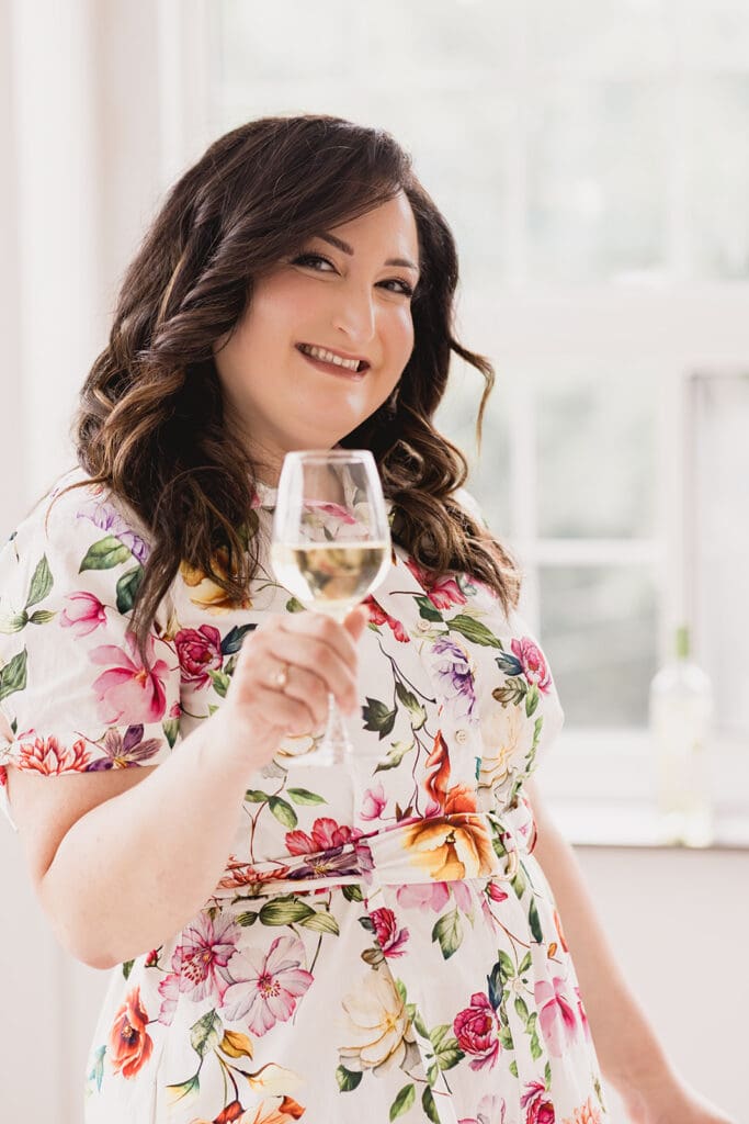 Photo of Mary, founder of Marycuterie, holding a glass of wine during a branding photoshoot with Portraits by Kendra in Kitchener-Waterloo